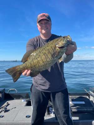 Smallmouth bass held over the water