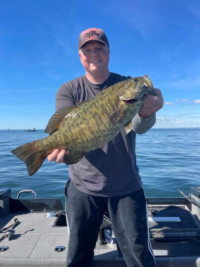 Smallmouth bass held over the water